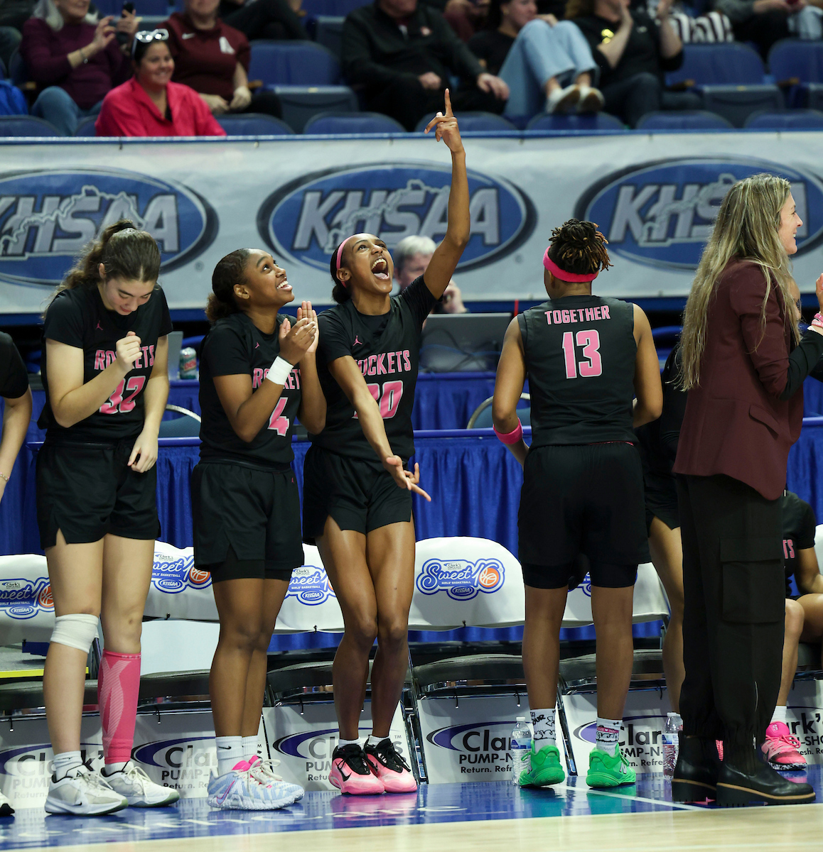 Assumption high school girls basketball bench celebrates a 3-pointer during the KHSAA Clark’s Pump-N-Shop Girls’ Basketball Sweet 16 tournament as Calloway County plays Assumption at Rupp Arena on Wednesday, March 11, 2026, in Lexington, Ky. Assumption defeated Calloway County 72-35. Photo by Holly Netzley