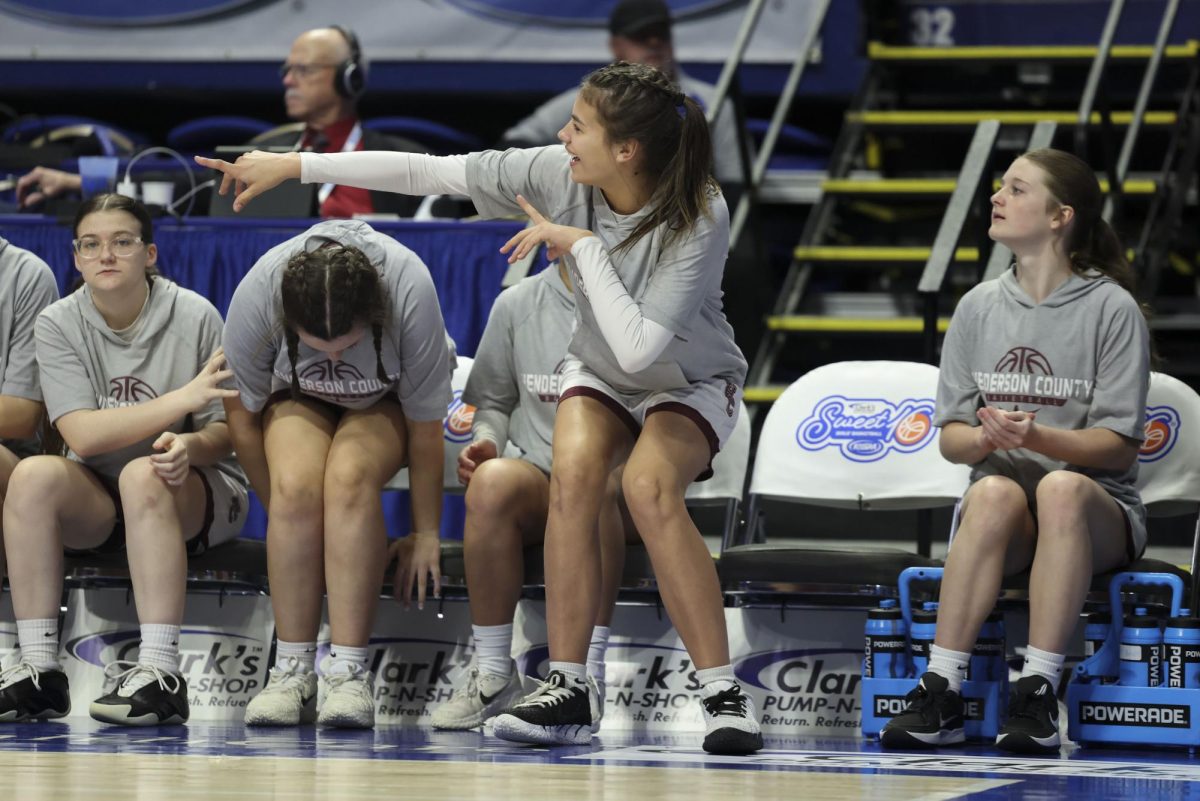 The Henderson County bench celebrates a made layup during the KHSAA Clark’s Pump-N-Shop Girls’ Basketball Sweet 16 tournament as Henderson County plays Frederick Douglass at Rupp Arena on Wednesday, March 11, 2026, in Lexington, Ky.. Photo by Kate Bonafede
