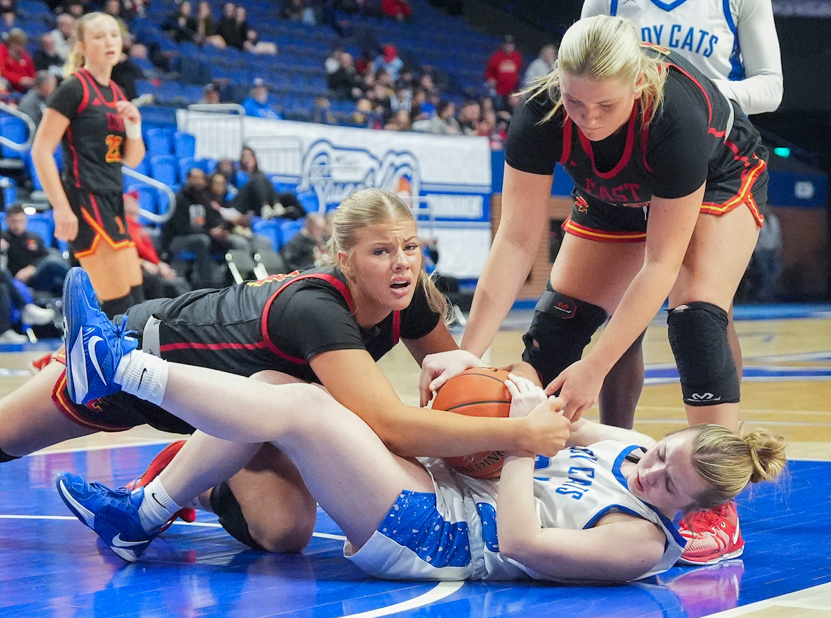 Bullitt East center Lyla Packer and Franklin-Simpson shooting guard Kenzie Taylor lay tangled up on the court as they both attempt to gain possession of a loose ball during the Clark’s Pump-N-Shop Girls’ Basketball Sweet 16 tournament as Franklin-Simpson plays Bullitt East at Rupp Arena on Thursday, March 12, 2026, in Lexington, Ky. Photo by Israel Schill