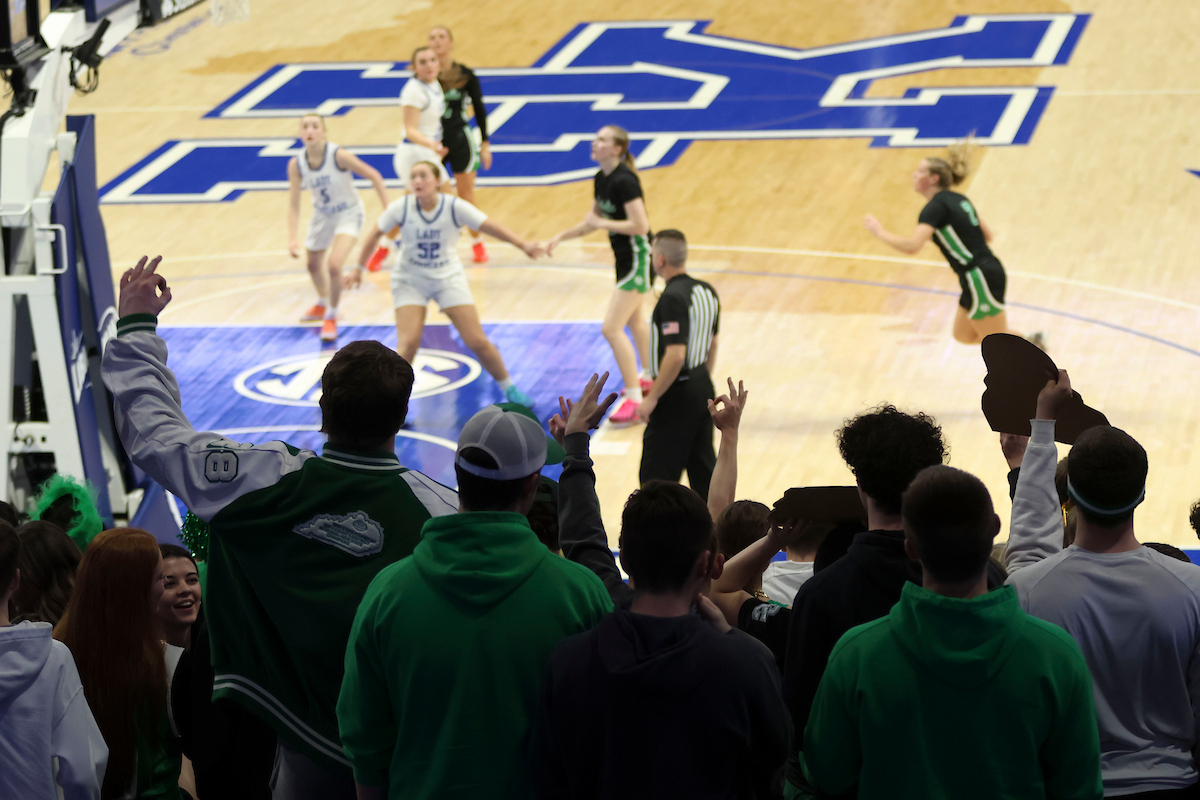 Owensboro Catholic student section celebrates during the KHSAA Clark’s Pump-N-Shop Girls’ Basketball Sweet 16 tournament as Letcher County Central plays Owensboro Catholic at Rupp Arena on Thursday, March 12, 2026, in Lexington, Ky. Photo by Holly Netzley.
