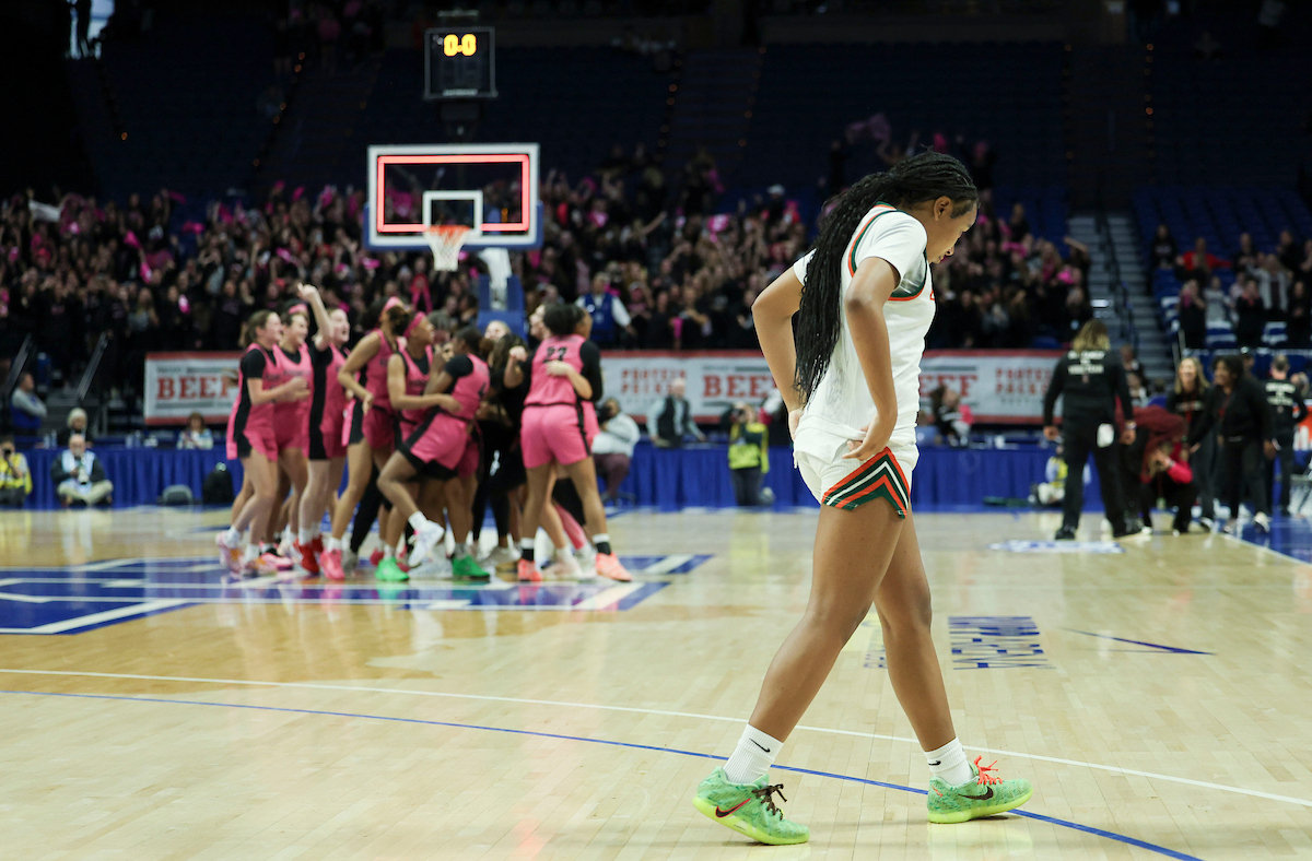 A Frederick Douglas player leaves the floor as Assumption celebrates their win during the Clark’s Pump-N-Shop Girls’ Basketball Sweet 16 tournament as Frederick Dourglass plays Assumption at Rupp Arena on Friday, March 13, 2026, in Lexington, Ky. Photo by Laura Silva